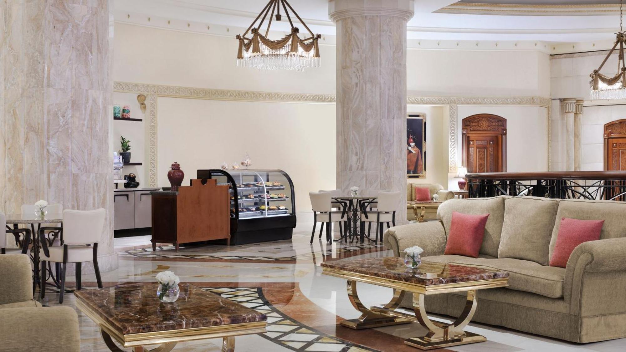 Intercontinental Dar Al Iman Madinah By Ihg Hotel Medina Eksteriør billede The photo shows a luxurious hotel lobby or lounge area. It features elegant marble floors and tall columns. There are comfortable seating arrangements with a sofa and stylish tables that have marble tops. A display case for pastries or refreshments i